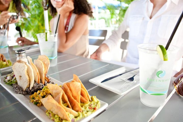 a woman sitting at a table with a plate of food