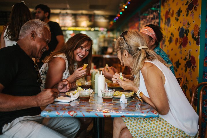 a group of people sitting at a table in a restaurant