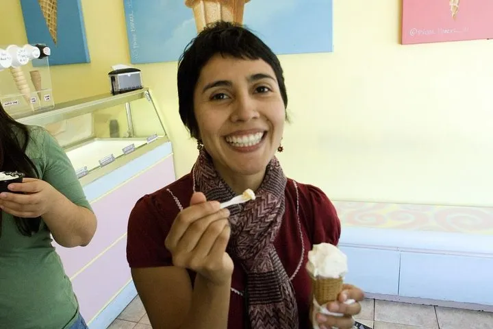 a woman standing in front of a mirror posing for the camera