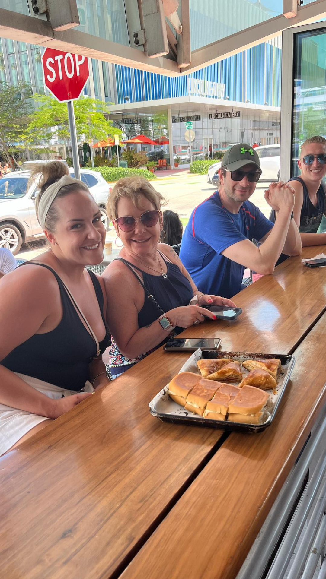 a group of people standing on top of a wooden table