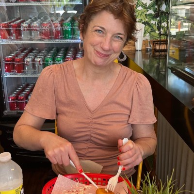 a person standing in front of a cake