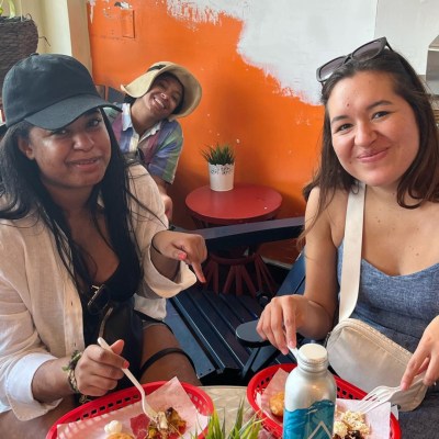 a woman sitting at a table with a cake