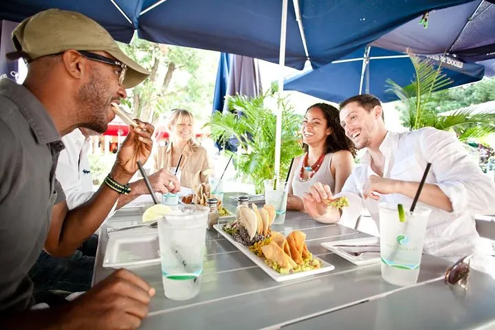 a group of people sitting at a table eating food