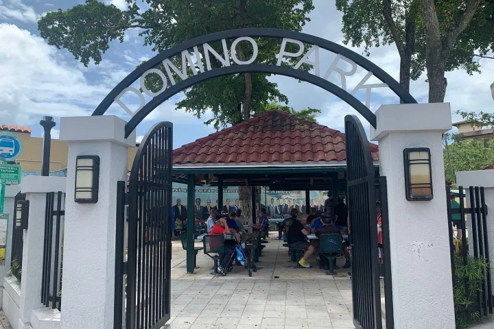 a group of people on a sidewalk next to a building