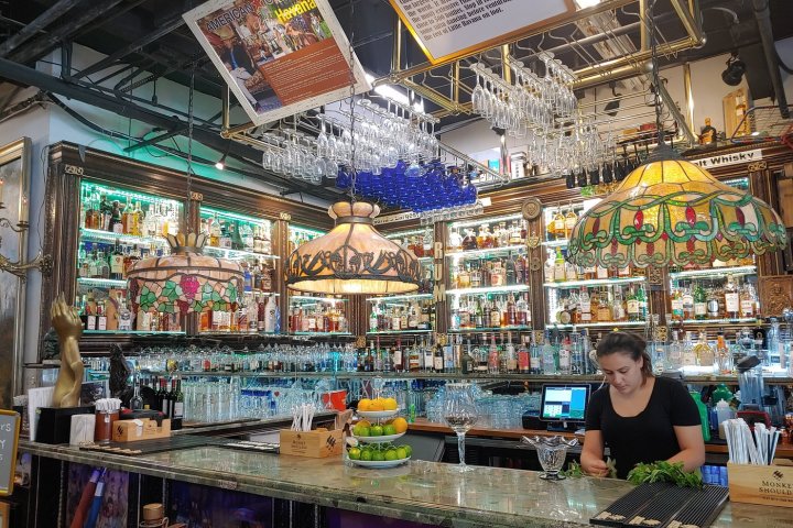 a group of people sitting at a table in front of a store