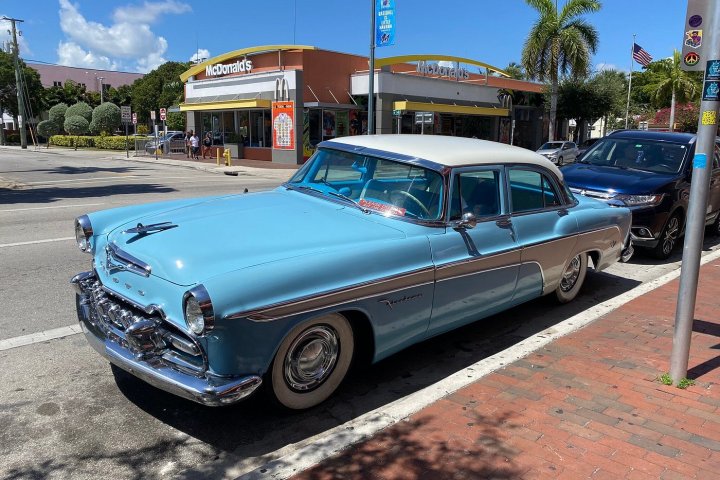 a blue car parked in a parking lot
