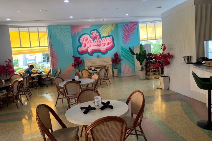 a living room filled with furniture and a large window