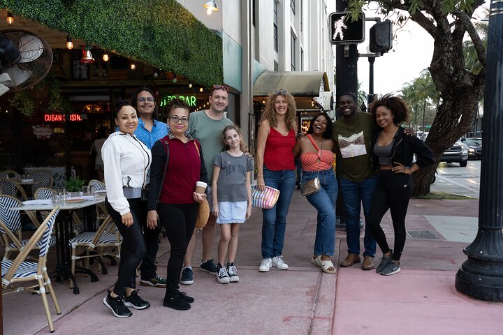 a group of people standing on a sidewalk