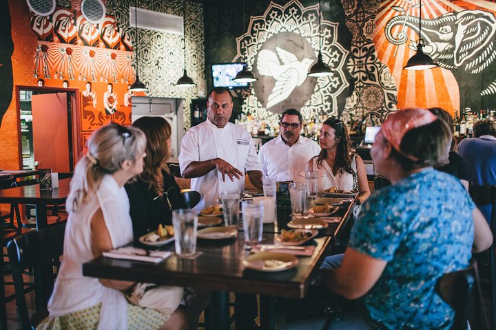 a group of people sitting at a table in a restaurant