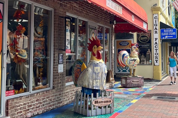 a group of people on a sidewalk in front of a store