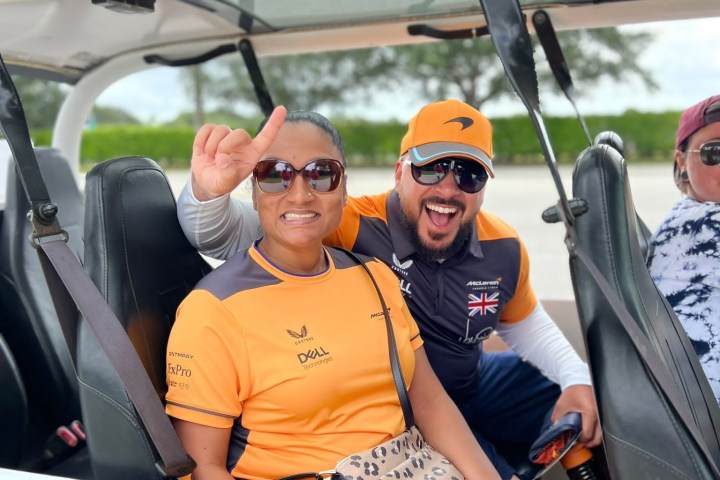a man standing in front of a car