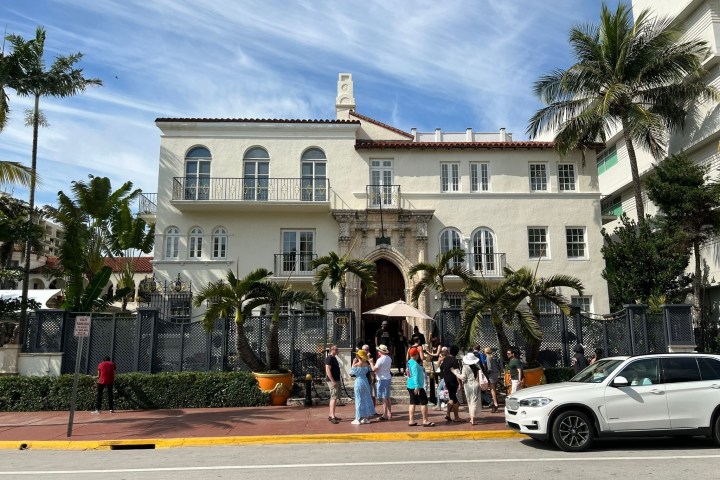 a group of people walking down the street in front of a building